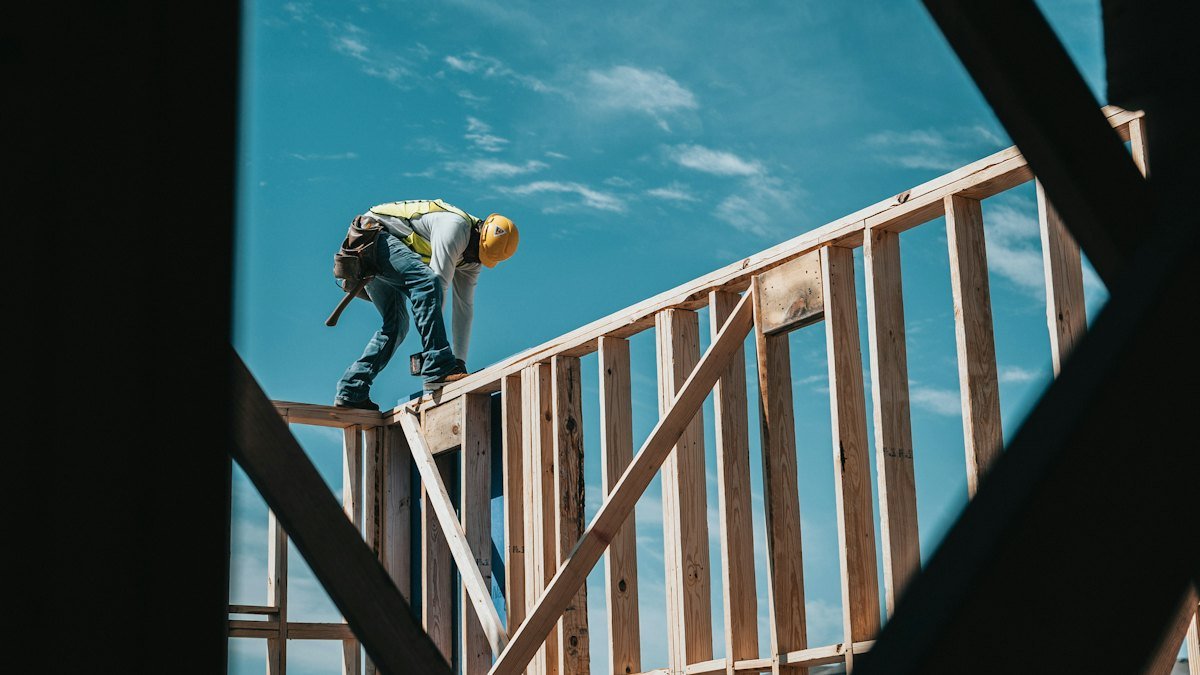Builder working on a timber house frame – website design for builders in Australia
