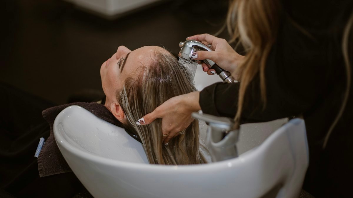 Hairstylist cutting a client’s hair – salon website design in Australia