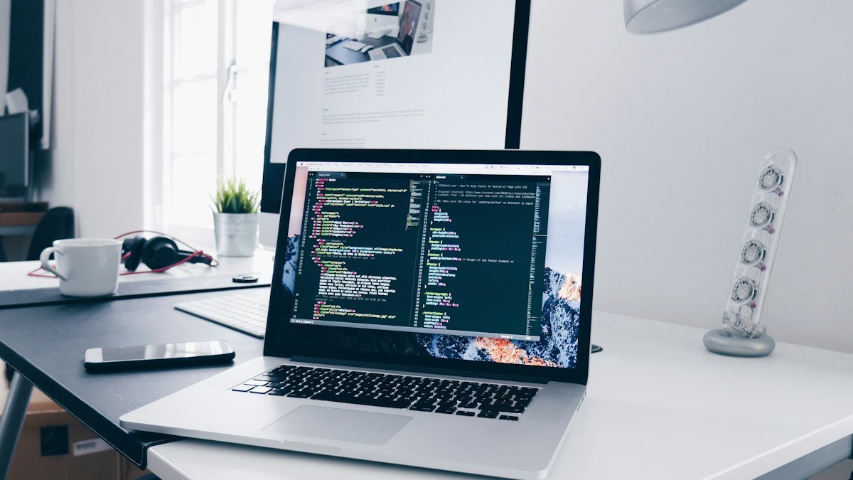 Laptop with website code on a desk – website development in Australia